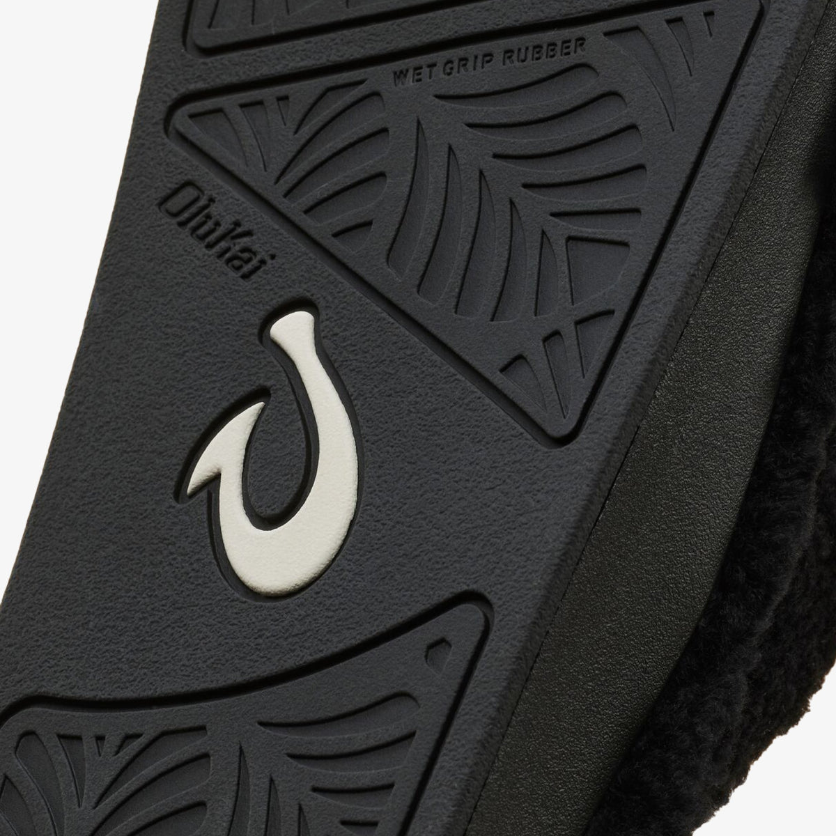 Black rubber sole with white hook logo and "Wet Grip Rubber" tread pattern.