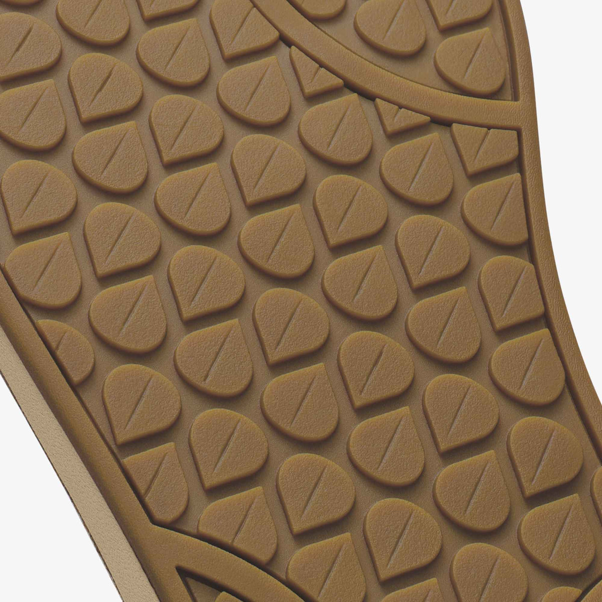 Tan rubber shoe sole with leaf-pattern tread design and white edge trim.
