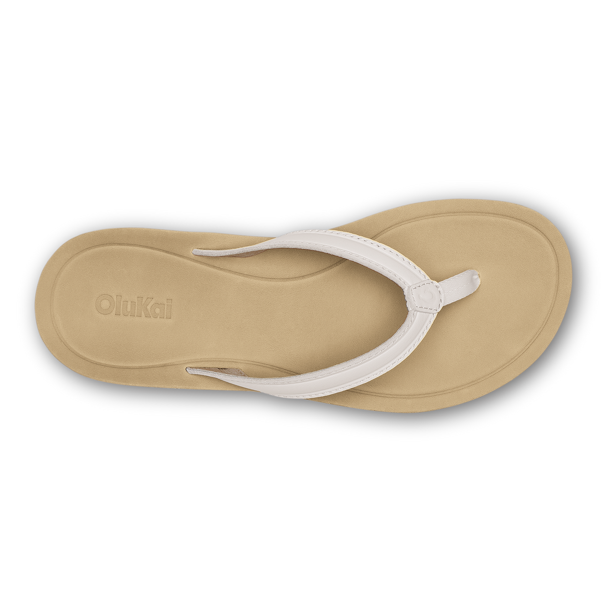 Warm sand flip-flop with bright white thong strap and OluKai branding on sole, viewed from above.