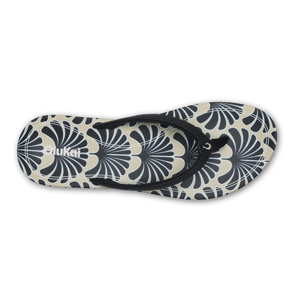 Black and cream flip-flop with geometric fan pattern design and black toe strap.