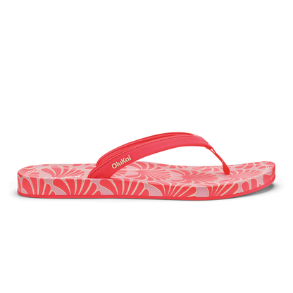 Hot pink flip-flop with shell pattern design and red toe strap.