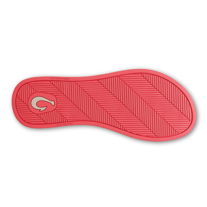 Hot pink shoe sole with diagonal tread pattern and logo detail on heel.