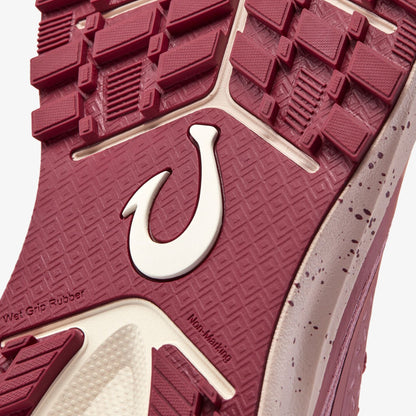 Coral rose and cream shoe sole with geometric tread pattern, horseshoe logo, and "Wet Grip Rubber" text visible.