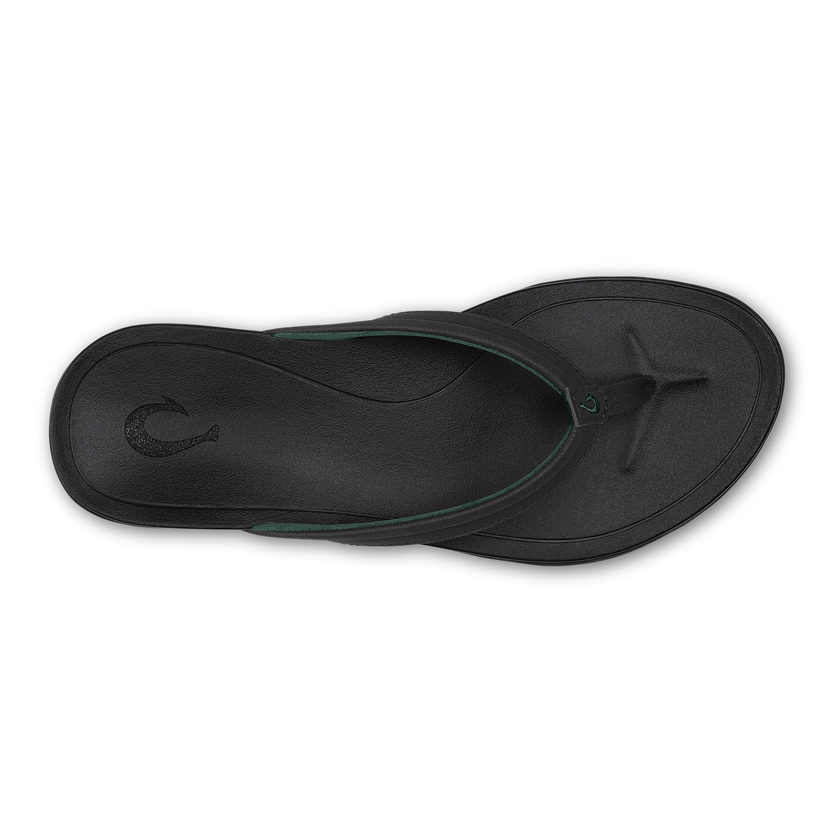 Black lava rock thong sandal with green accent strap viewed from above.