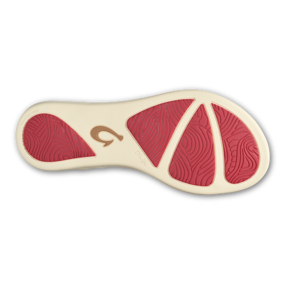 Shoe sole featuring hot pink tread sections with cream-colored base and brown brand logo.