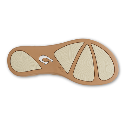 Sandal sole view showing tan rubber outsole with cream-colored textured footbed and traction pattern.
