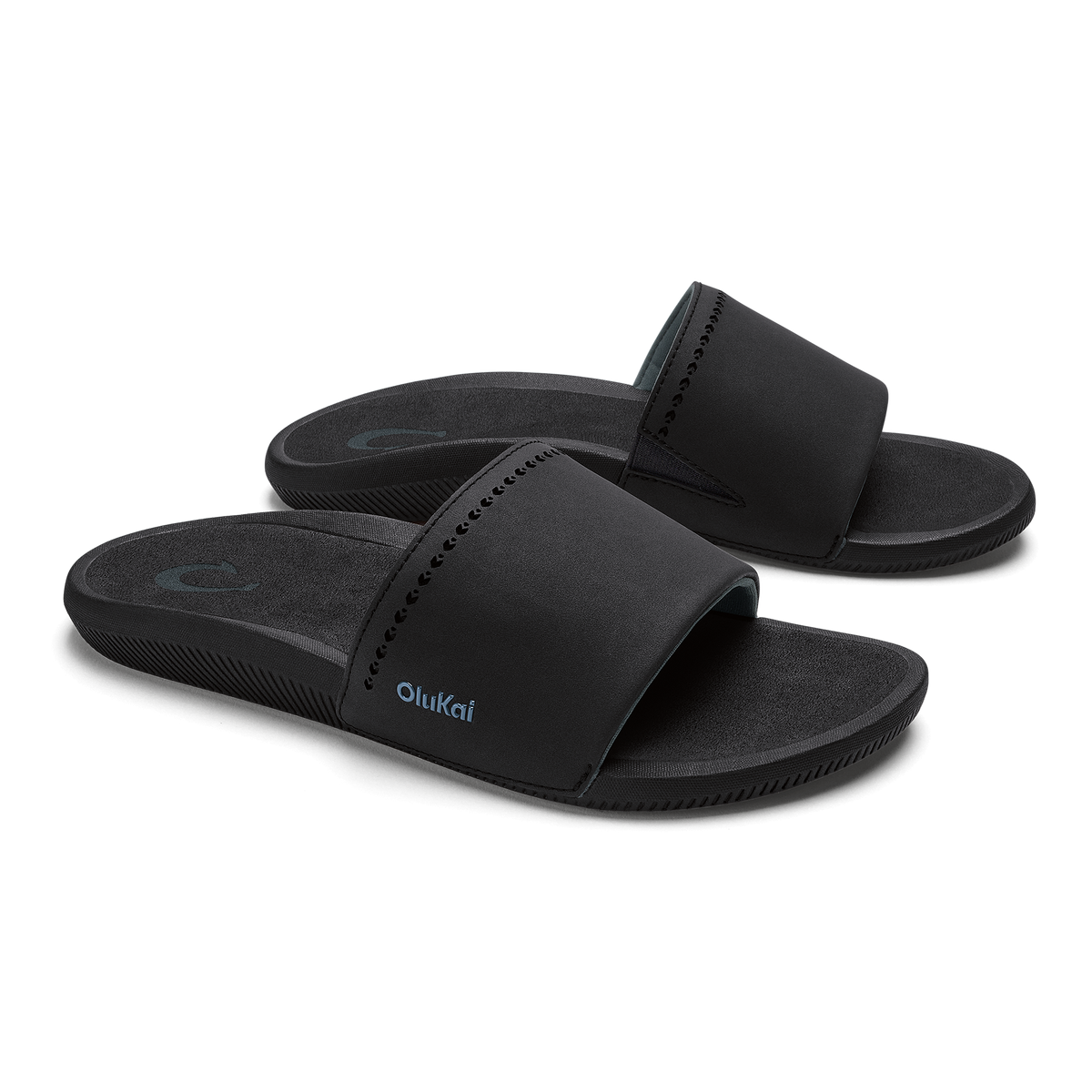 Black slide sandals with padded straps and textured soles, shown from a front angle view.