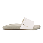 White and tan slide sandal with ribbed sole and decorative stitching on upper strap.