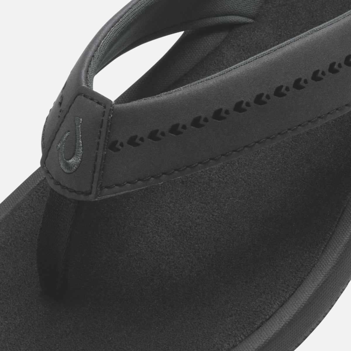 Black slide sandal with textured strap featuring decorative cutout details and padded footbed.