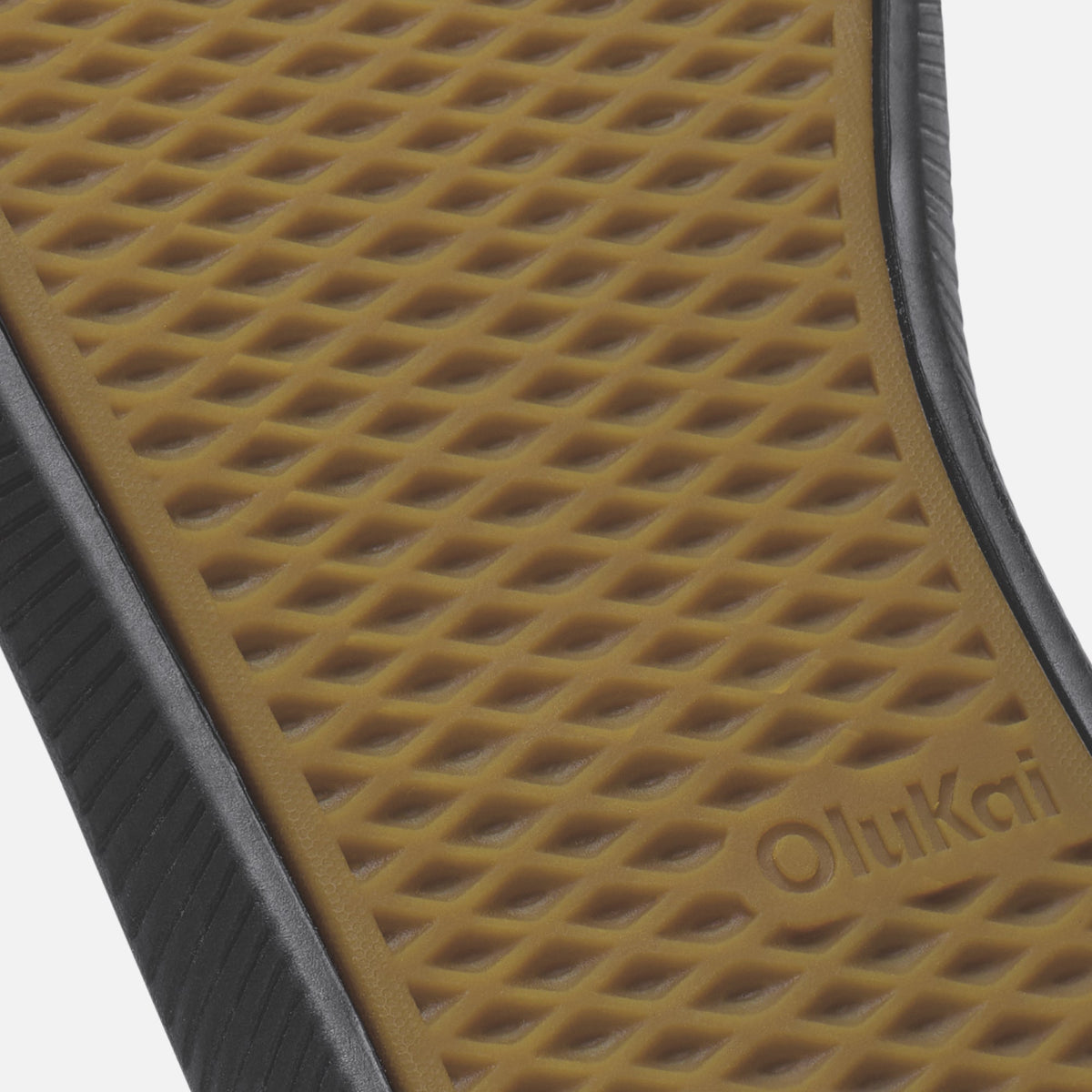 Tan waffle-textured sole with black rubber sidewall and "OluKai" branding visible.