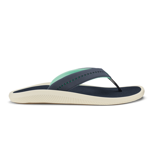 Trench blue thong sandal with mint green strap detail and cream-colored textured sole.
