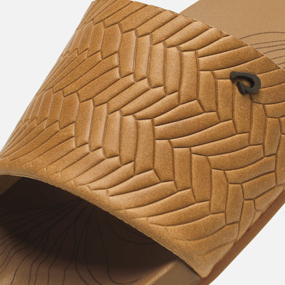 Tan leather bag with geometric weave pattern and dark metal clasp detail.