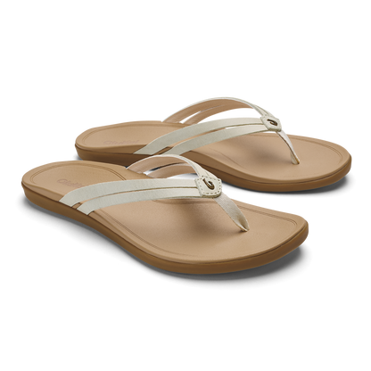 Pair of tan and cream flip-flop sandals with thong straps and cushioned footbeds.