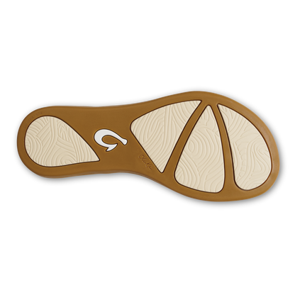 Brown and tan tapa-patterned serving spoon with curved handle and segmented bowl design.