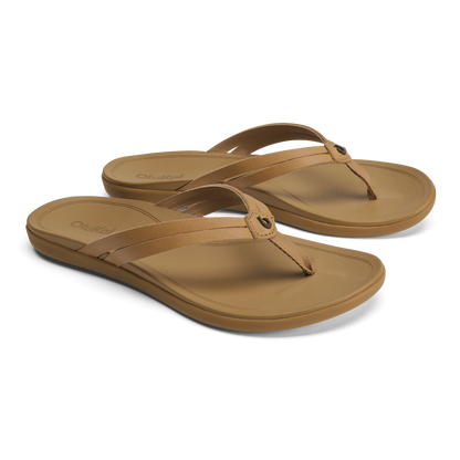 Pair of tan leather thong sandals with cushioned soles and adjustable straps.