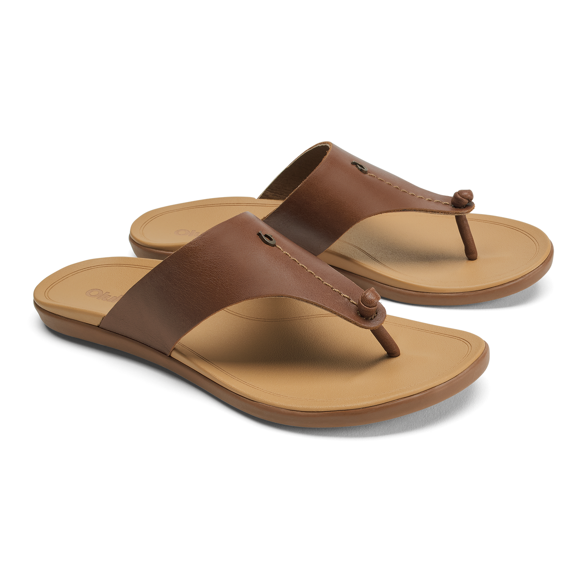 Pair of brown leather thong sandals with tan soles and decorative button details on the straps.