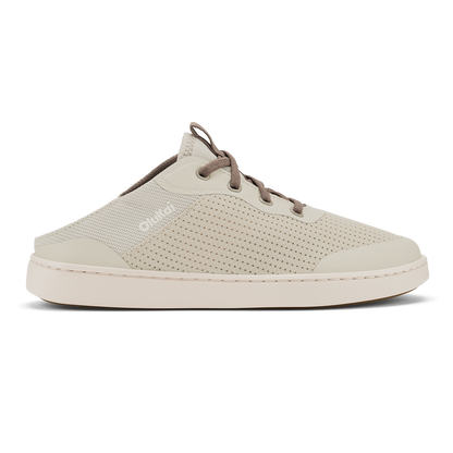 Cream-colored slip-on clog with perforated mesh upper, brown cord laces, and white rubber sole.