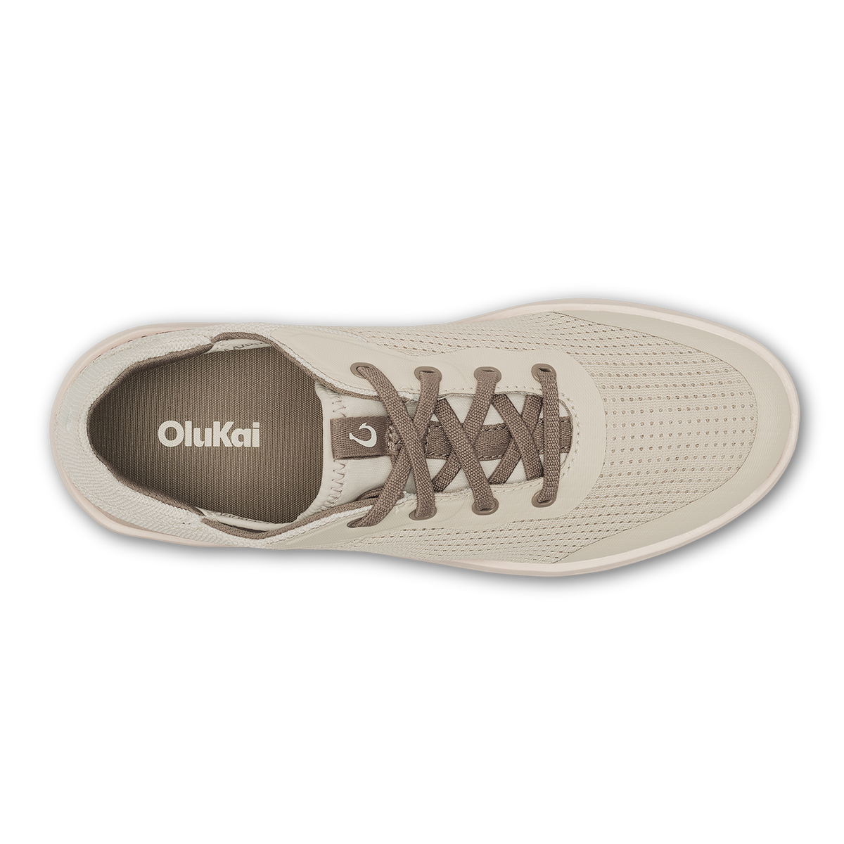 Cream-colored OluKai sneaker with perforated upper, brown laces, and visible brand logo on tongue, shown from above.