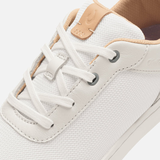 White lace-up sneaker with cantalope-colored leather heel tab and textured mesh upper.