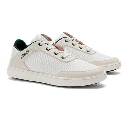 Pair of white lace-up sneakers with cream and beige panels, brown heel accents, and green interior lining.