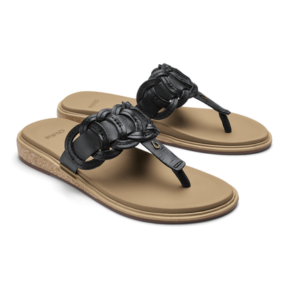 Black thong sandals with ruched leather straps and warm sand-colored footbeds, shown in two angles.