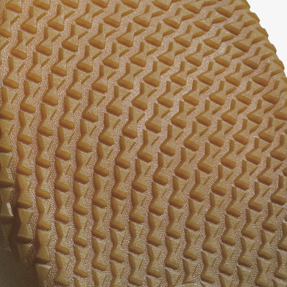 Cream-colored fabric with geometric quilted diamond and zigzag pattern texture.