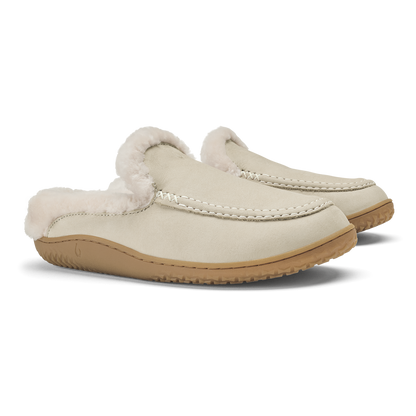 Pair of ecru slip-on loafers with fleece lining and tan rubber sole.