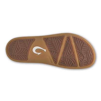Tan and dark brown sandal sole with leaf-pattern tread and white brand logo.