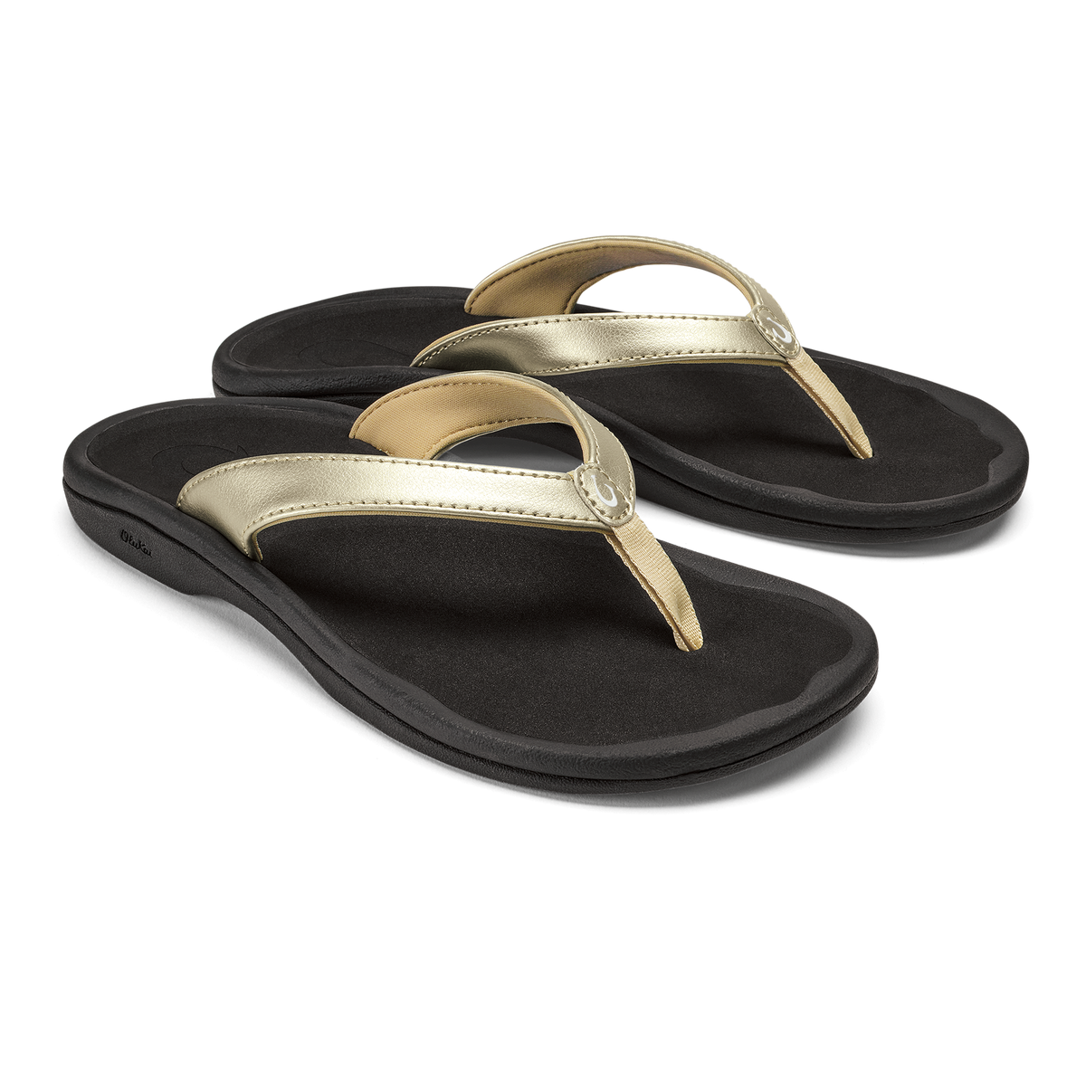 Pair of black flip-flops with gold and metallic straps and cushioned soles.