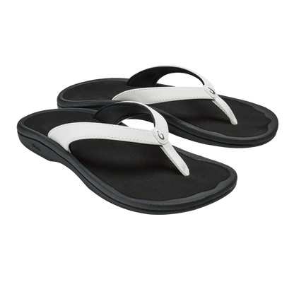Pair of black flip-flops with white straps and curved black footbeds.