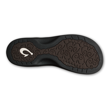 Black shoe sole with brown patterned footbed, white logo, and textured tread pattern.