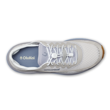 White and blue OluKai Ahi sneaker with white laces and gum sole, shown from above.