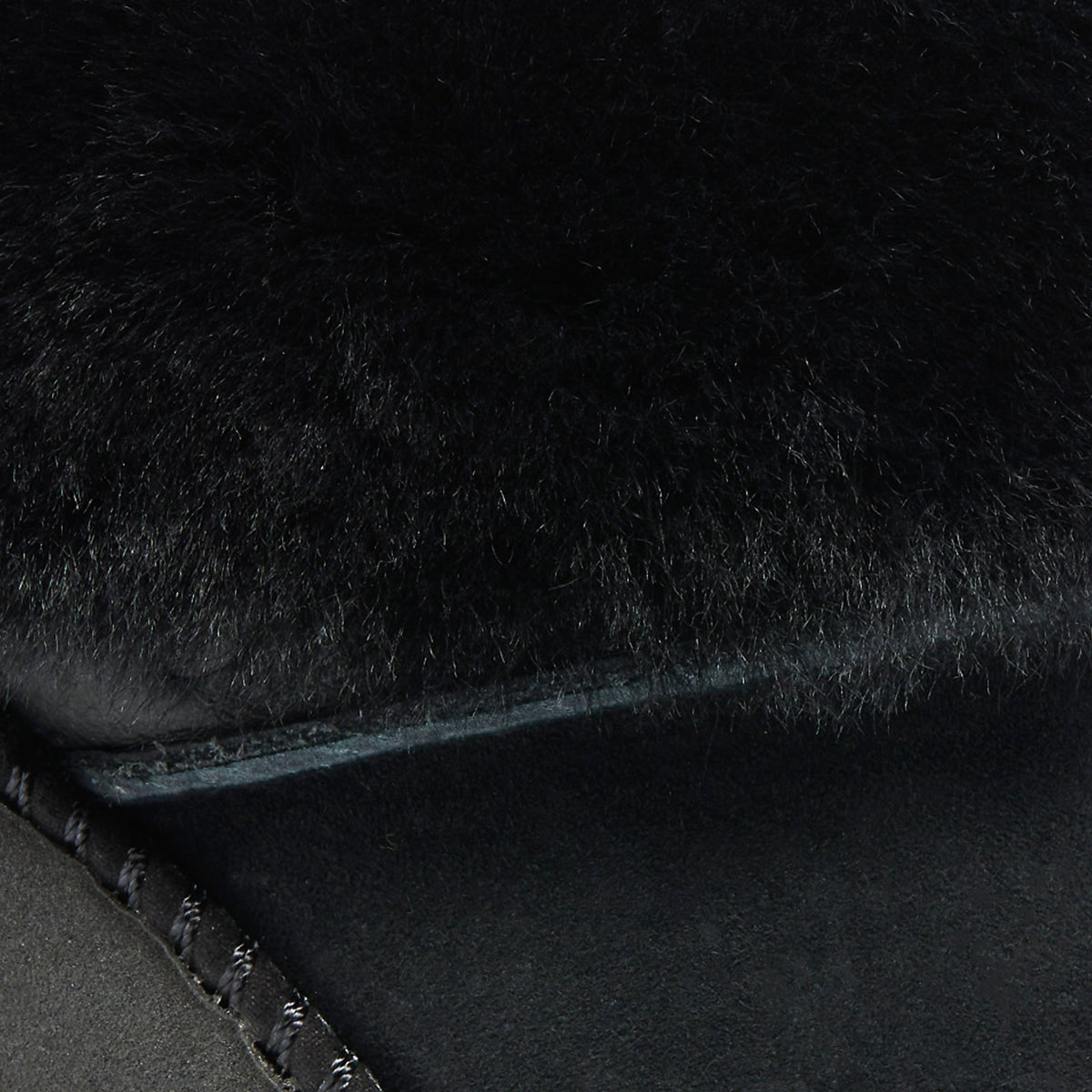 Black lava rock surface with rough, porous texture and irregular edges.