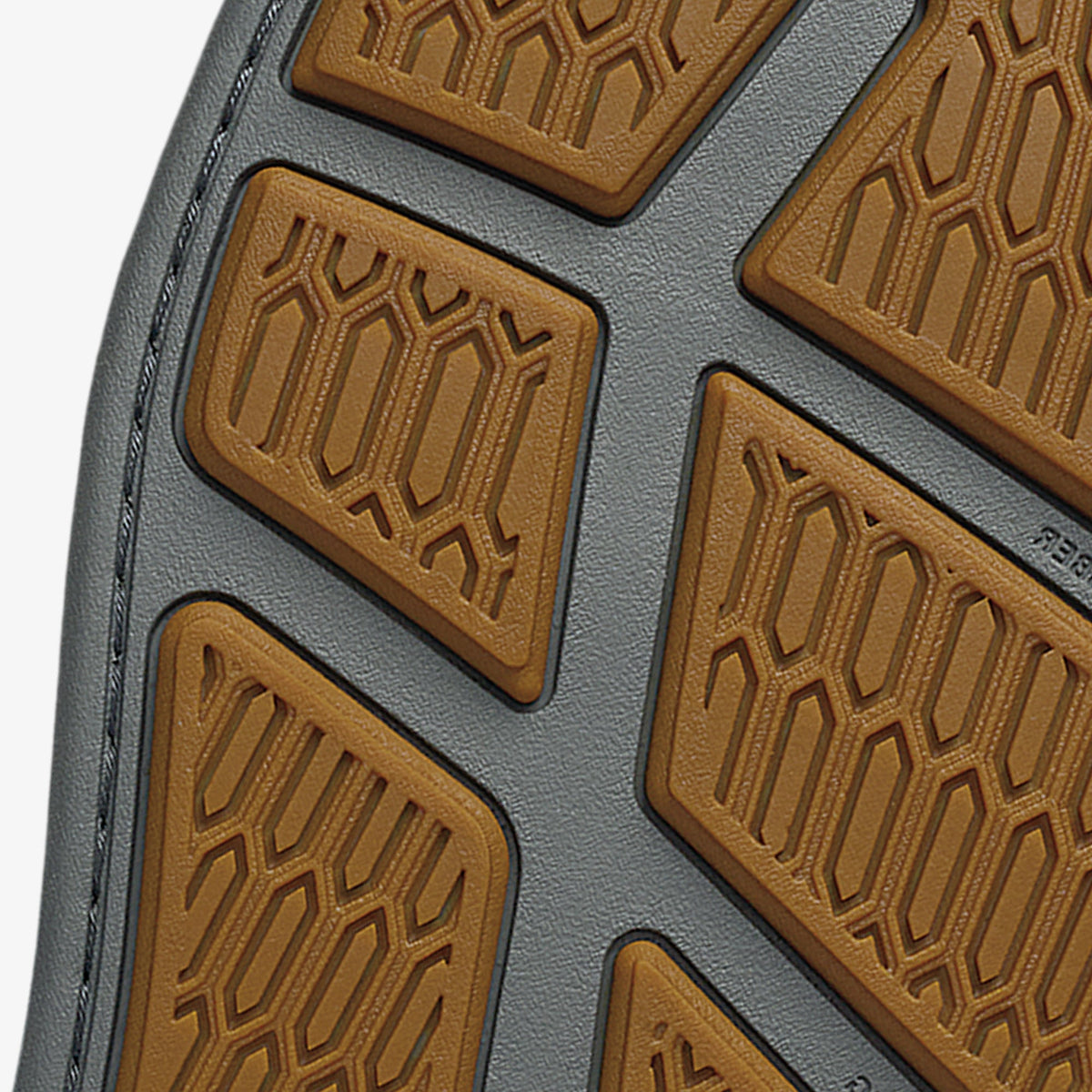 Brown textured sole patches on gray rubber base with geometric pattern detailing.
